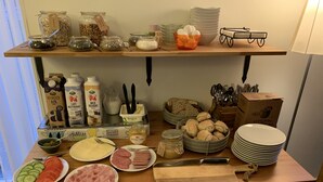 A breakfast buffet with various food items, including fruits, bread, and dairy products. - Ljungs Fem Rum (Gotlands Tofta)