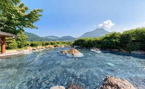 A clear river with rocks, surrounded by greenery and mountains in the background. - Musouen (Yufu)