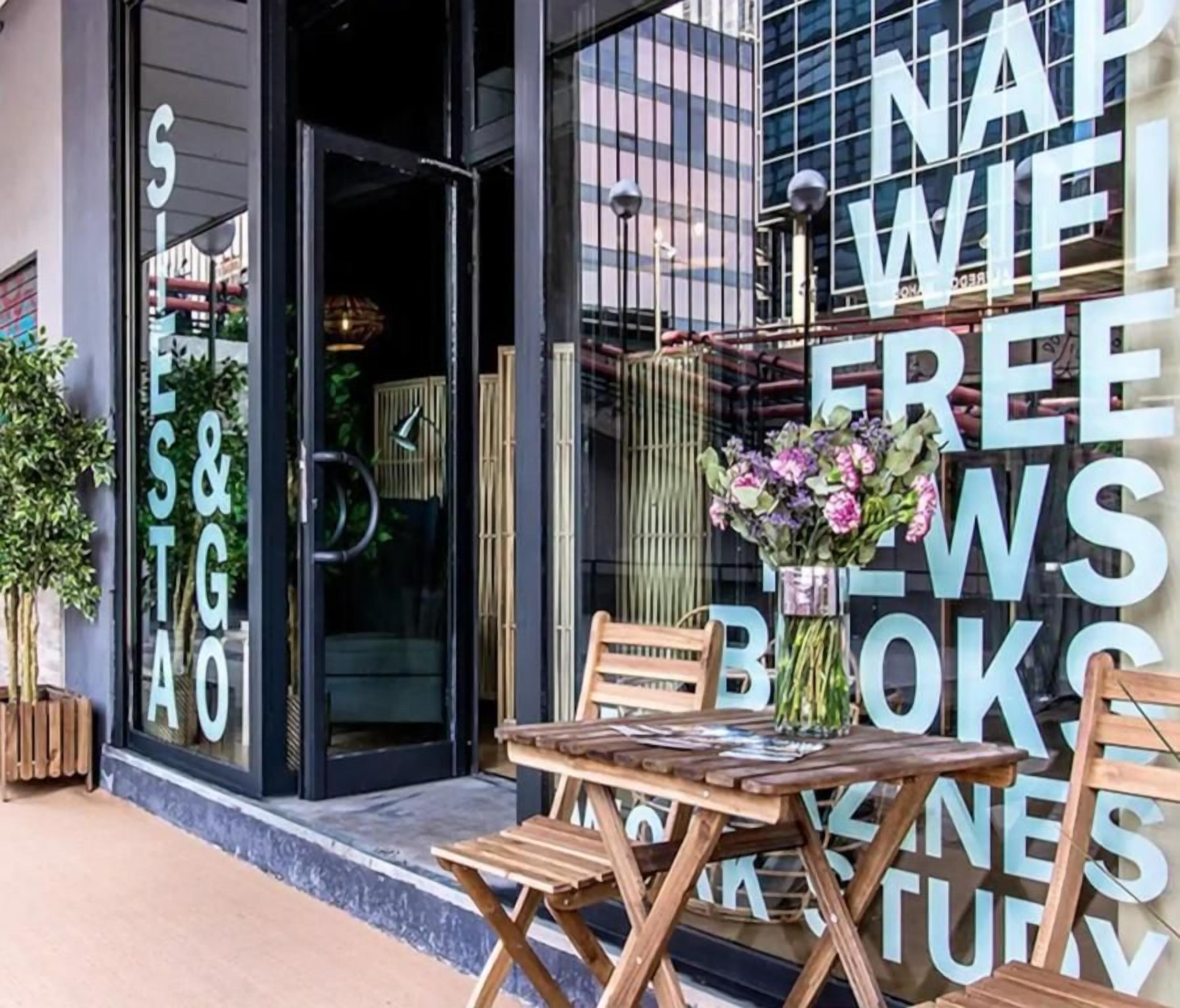 A storefront with a large sign advertising 'NAP WIFI FREE BLOWKS.'