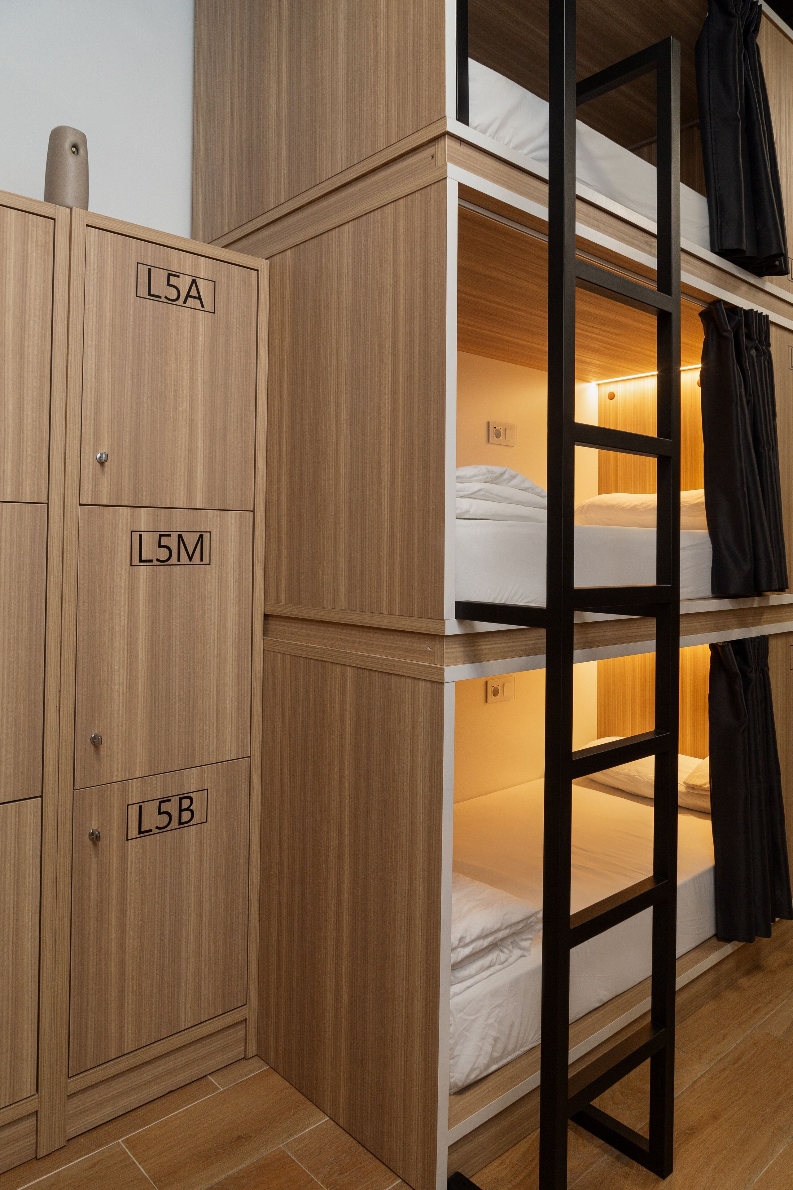 A bunk bed room with wooden cabinets labeled L5A, L5M, and L5B.