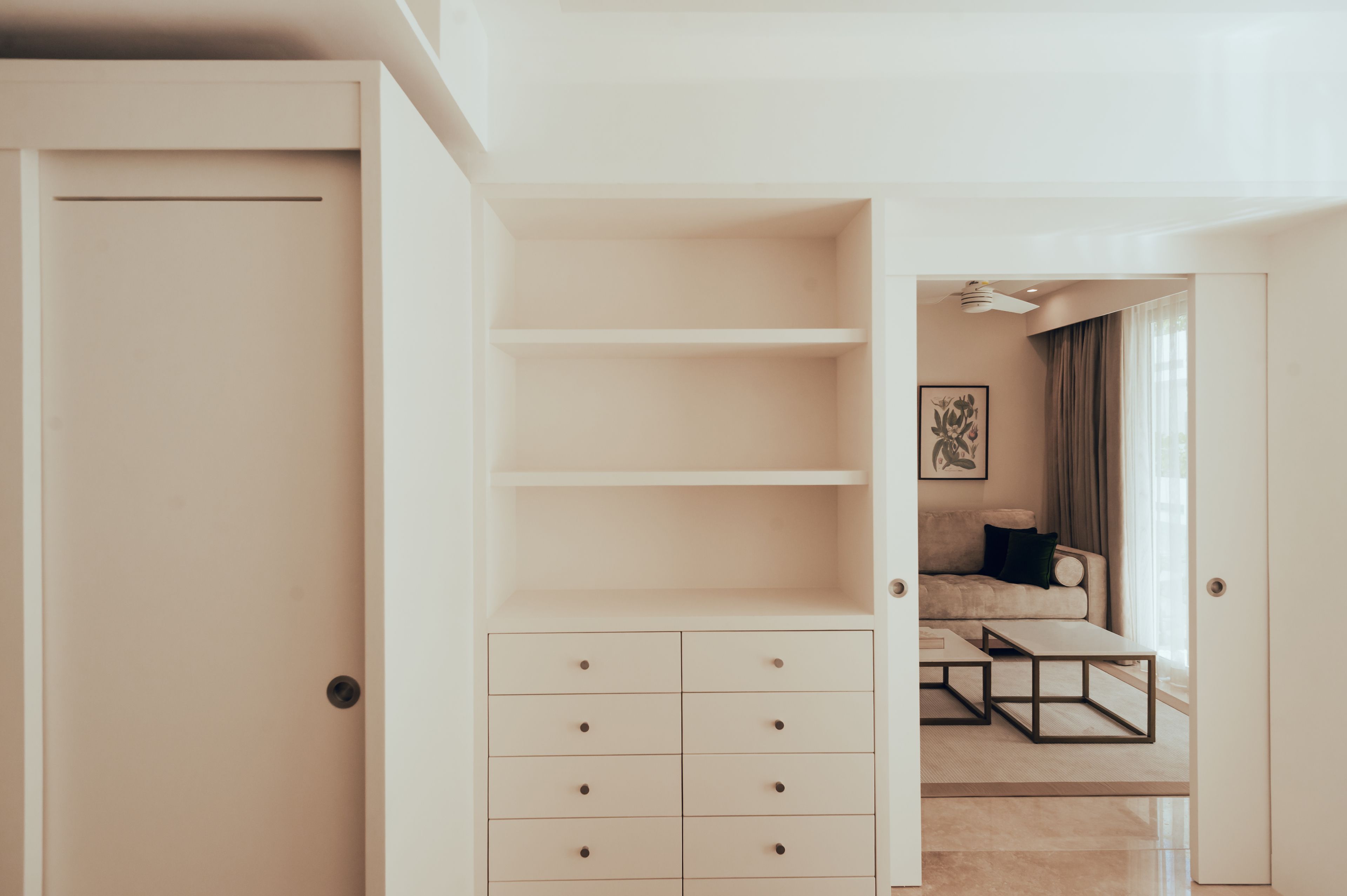 A minimalist room with a built-in wardrobe, a sofa, and a coffee table.
