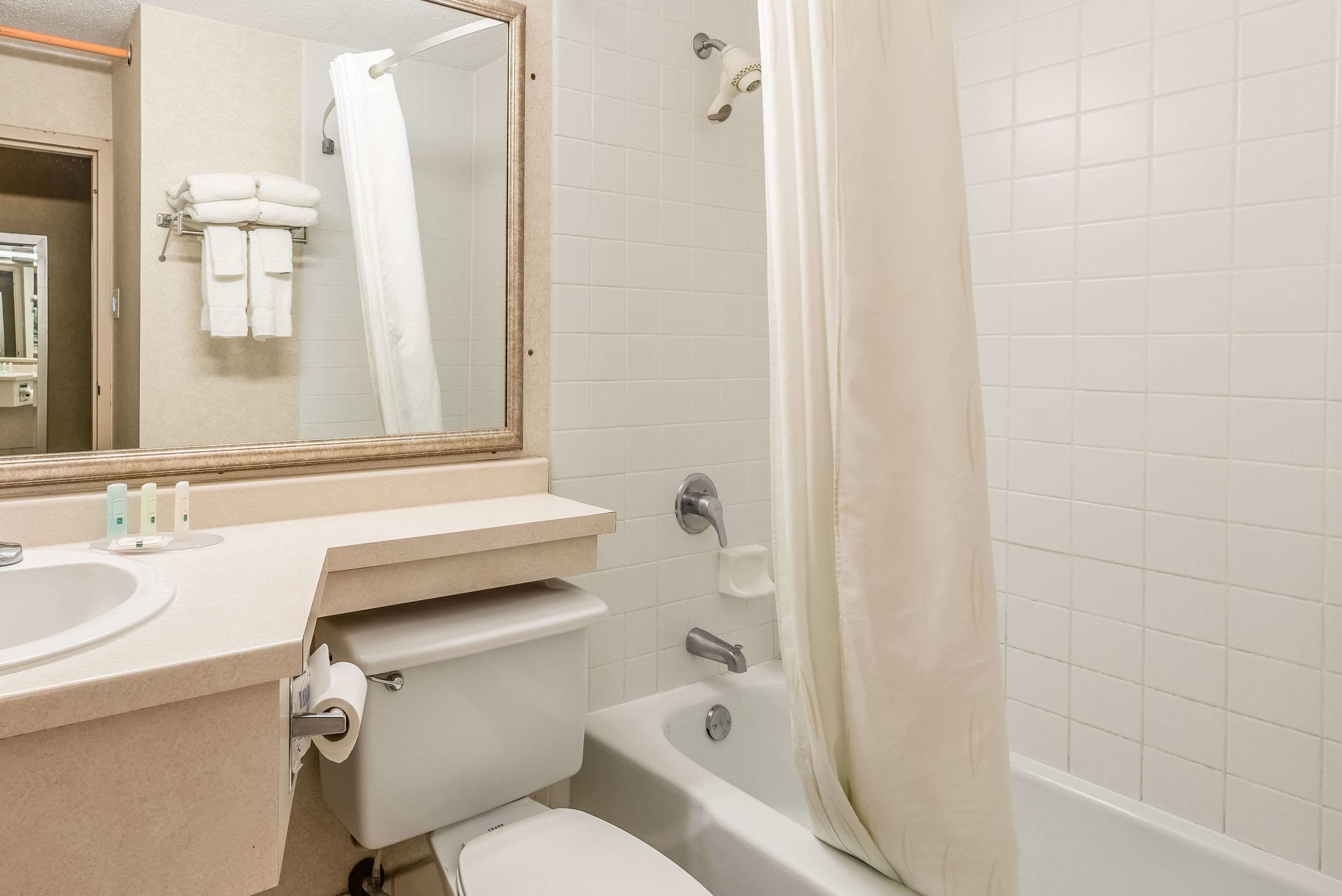 A bathroom with a sink, toilet, and bathtub.