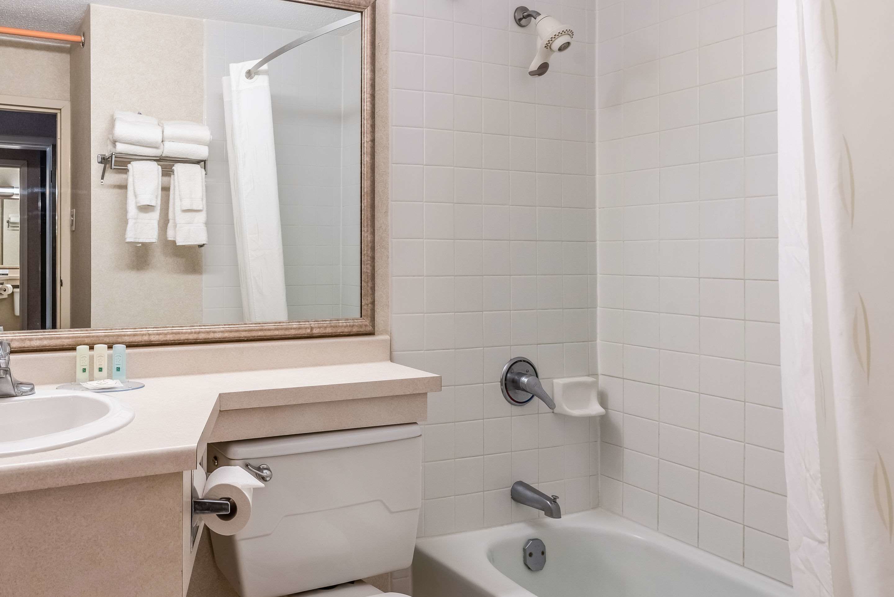 A bathroom with a sink, toilet, and bathtub.