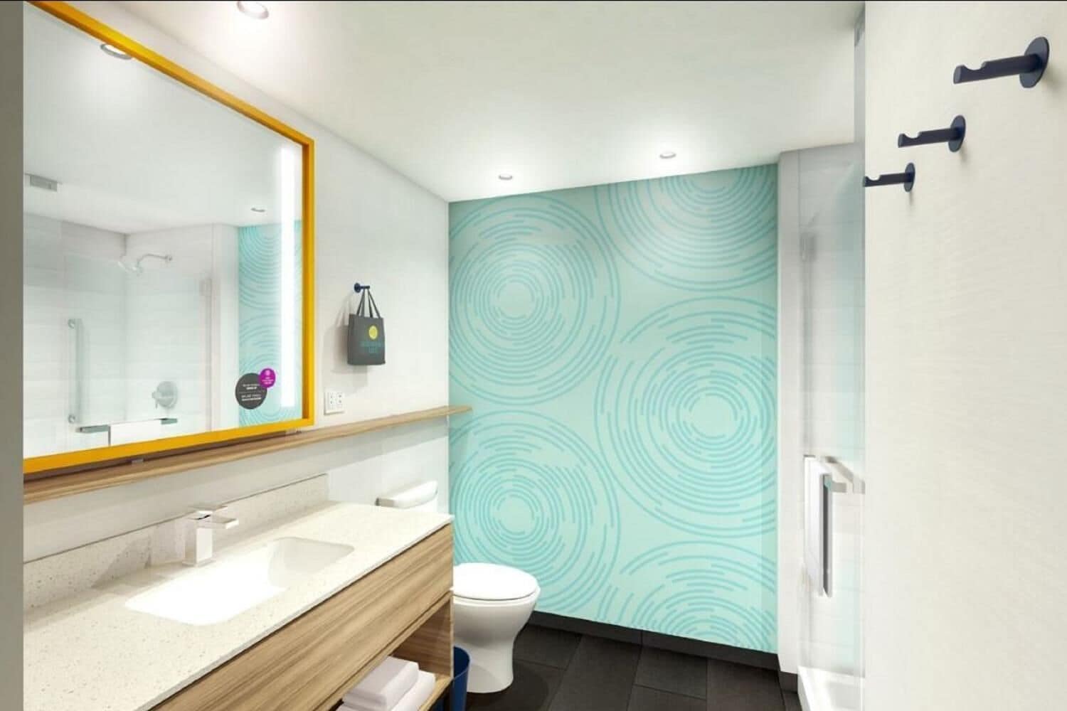 Un baño moderno con un espejo grande, dos lavamanos, un inodoro y una zona de ducha.