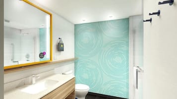 Un baño moderno con un espejo grande, dos lavamanos, un inodoro y una zona de ducha.