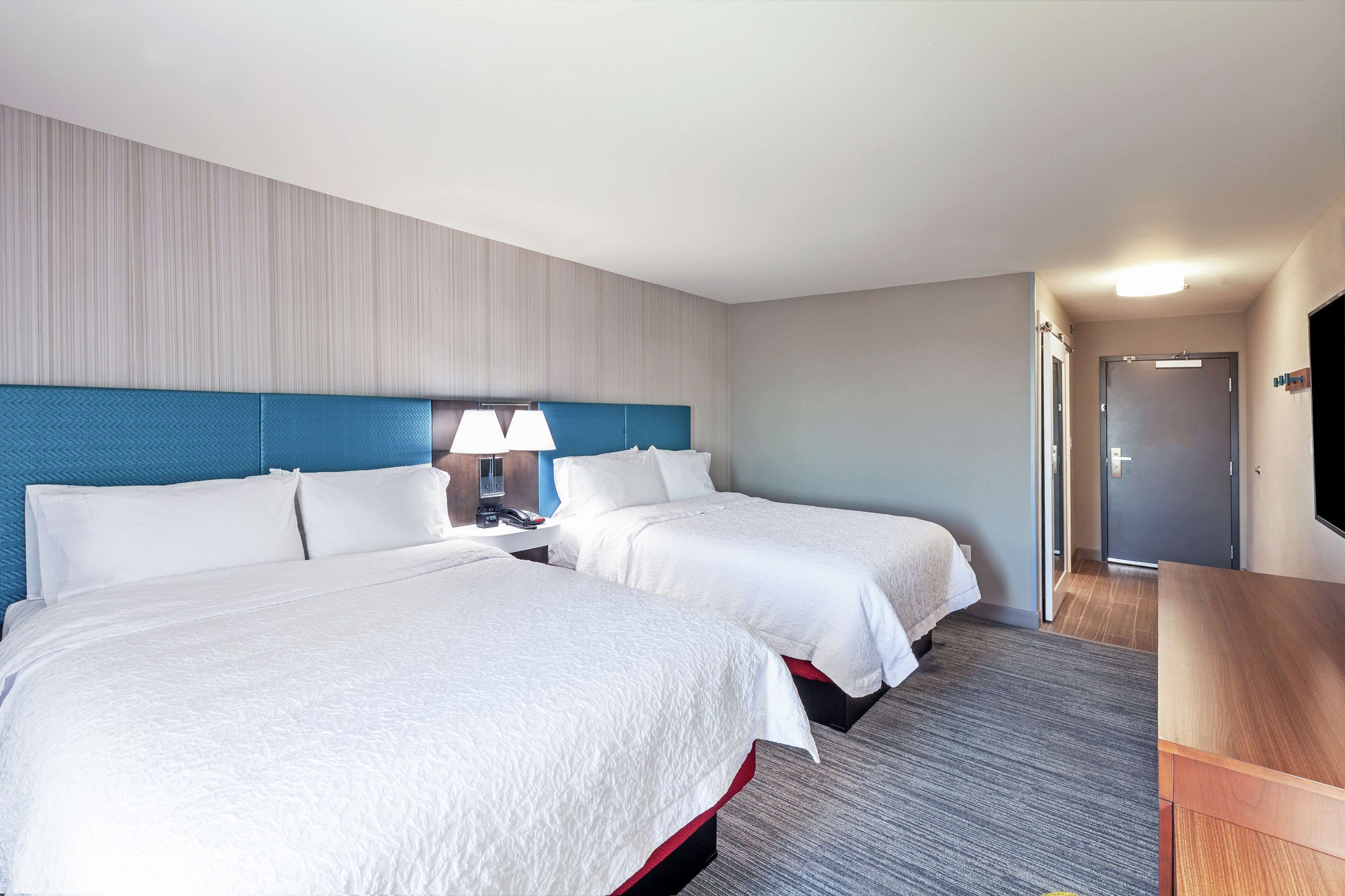 room, 2 queen beds, refrigerator | premium bedding, in-room safe, free cots/infant beds, free rollaway beds