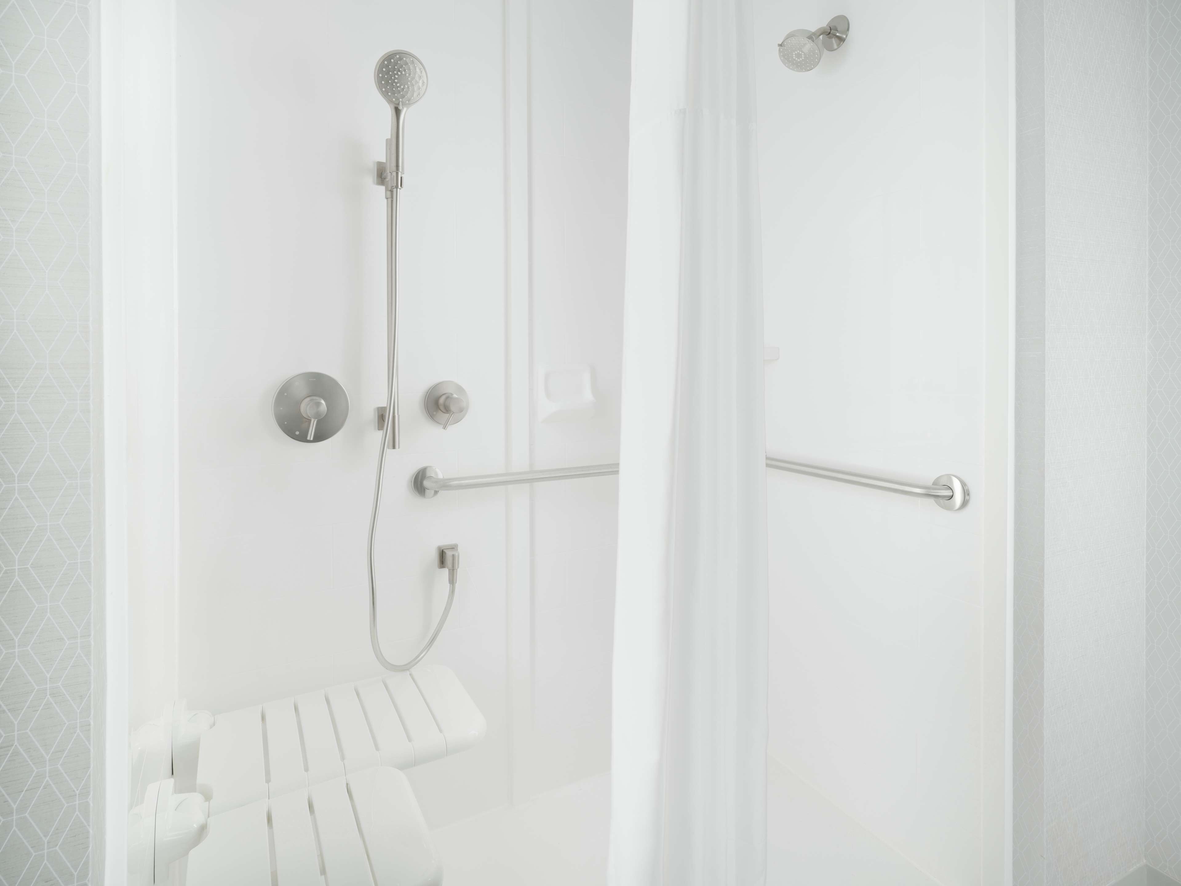 A modern bathroom with a shower, toilet, and towel rack.