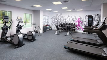 A gym with treadmills, stationary bikes, and weight machines.