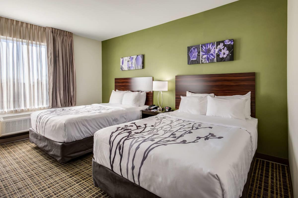 Premium bedding, desk, laptop workspace, blackout drapes
