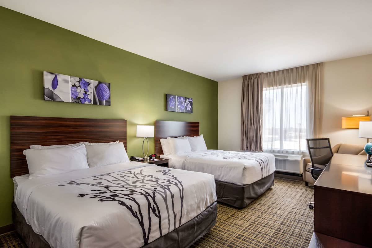 Premium bedding, desk, laptop workspace, blackout drapes