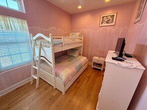 A bedroom with a bunk bed, a desk with a computer, a lamp, and a picture on the wall. - Panoramic Ocean Views, 2 Large Decks, and Direct Beach Access! (North Wildwood)