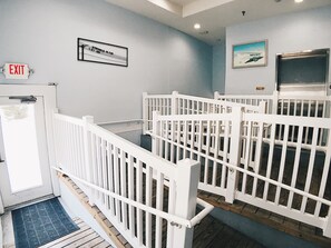 A staircase with white railings leading to a landing.