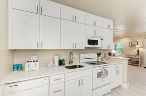 Fridge, microwave, oven, stovetop - Blue Bayou: Dog Friendly Home - 5 Houses to Beach by Anna Maria Life Vacation Rentals (Holmes Beach)