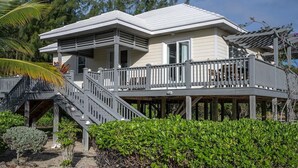 A two-story house with a balcony and a covered porch.