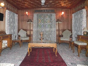 Classic design with wooden paneling, two chairs, and a wooden table.