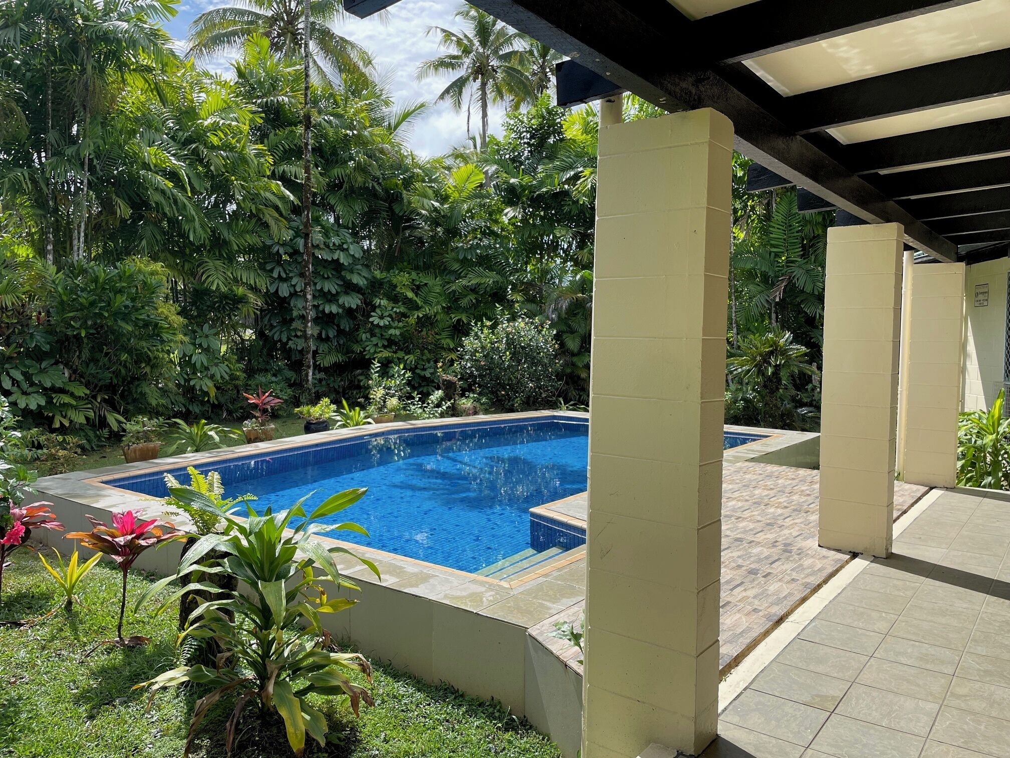 Refreshing private pool surrounded by lush foliage.