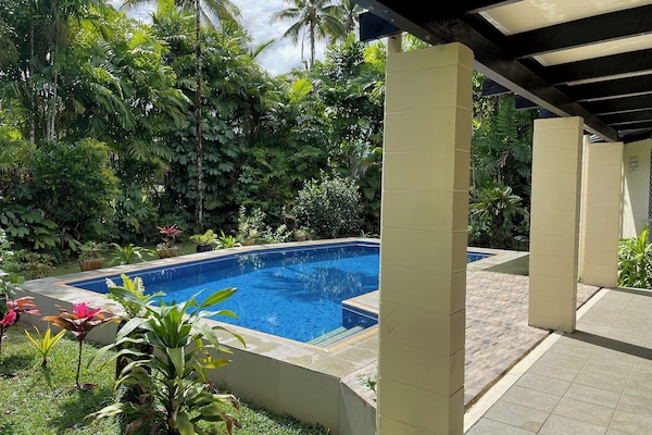 Refreshing private pool surrounded by lush foliage.