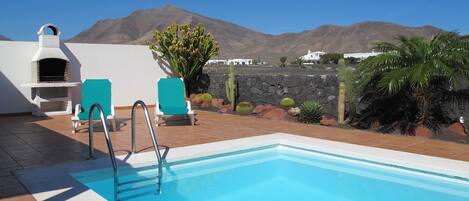 A heated pool, pool loungers