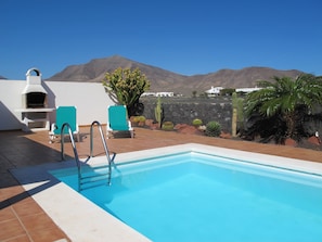 A heated pool, pool loungers