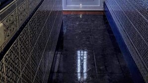 A hallway with a white door, patterned walls, and a dark tiled floor. - Casa Junonia Apartments, with terrace, Bajo C (Playa de Santiago)