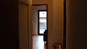 A narrow hallway with wooden flooring and a sloped ceiling. - Very nice apartment with a large sun terrace (Stadtkyll)