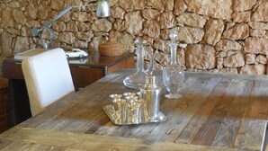 A wooden table with a metal tray, a car model, and a stone wall in the background. - Charming Villa of 150m2 with swimming pool and garden near sea (Carry-Le-Rouet)