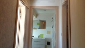 A narrow hallway with wooden ceiling beams and a light fixture. - Le Gîtele: Cottage 7 people to Chatenois (Châtenois)