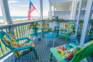 Relax in this inviting outdoor seating area with comfortable chairs and a potted plant.