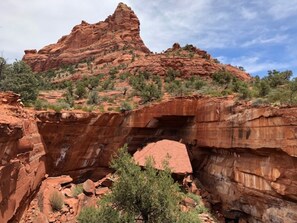 A canyon with red rock formations and sparse vegetation. - Spectacular Sedona,  Sunrise to Sunset! (Sedona)