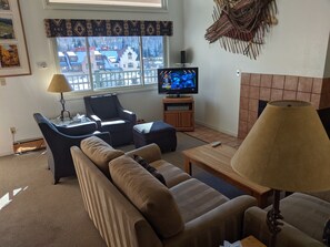 Relax in this inviting space with a sofa, armchairs, and a flat-screen TV for entertainment.