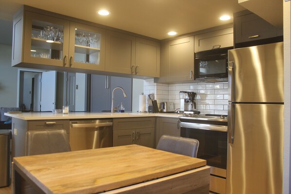 Enjoy cooking in this well-equipped kitchen with a refrigerator, microwave, oven, and dishwasher.