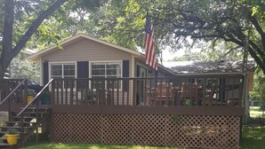 A house with a deck, a staircase, and an American flag. - LBJ Waterfront Retreat-Large Quiet Cove, Great Views, Family Friendly, Discounts (Granite Shoals)