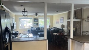 A spacious kitchen with a dining area, a large island, and a view to the living room. - LBJ Waterfront Retreat-Large Quiet Cove, Great Views, Family Friendly, Discounts (Granite Shoals)