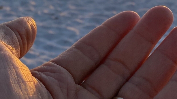 A hand with a ring against a sunset beach scene. - 5 STAR RATED, GREAT PRICES NEW FULLY RENOVATED IS WAITING FOR YOU 3 BEDROOM E112 (Indian Shores)