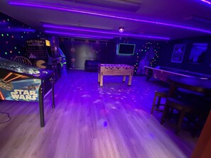Relax in a room with a foosball table and arcade games, including a classic Pac-Man machine.