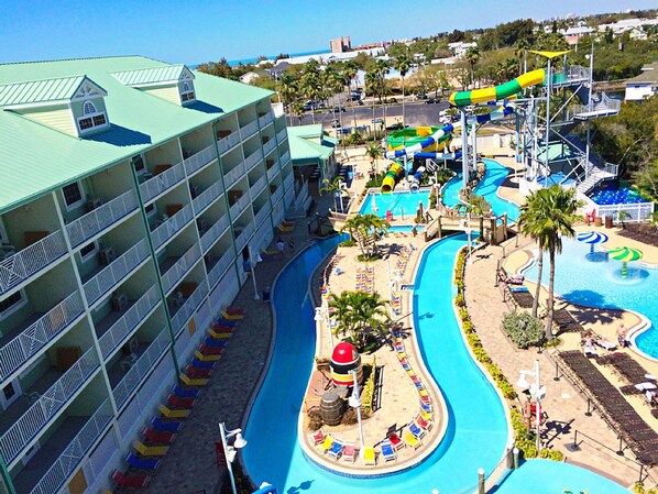 A hotel with multiple balconies, a swimming pool, and a water park.