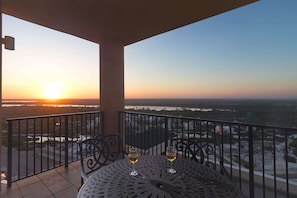 Enjoy a tranquil sunset view from this balcony with a glass of wine in hand.