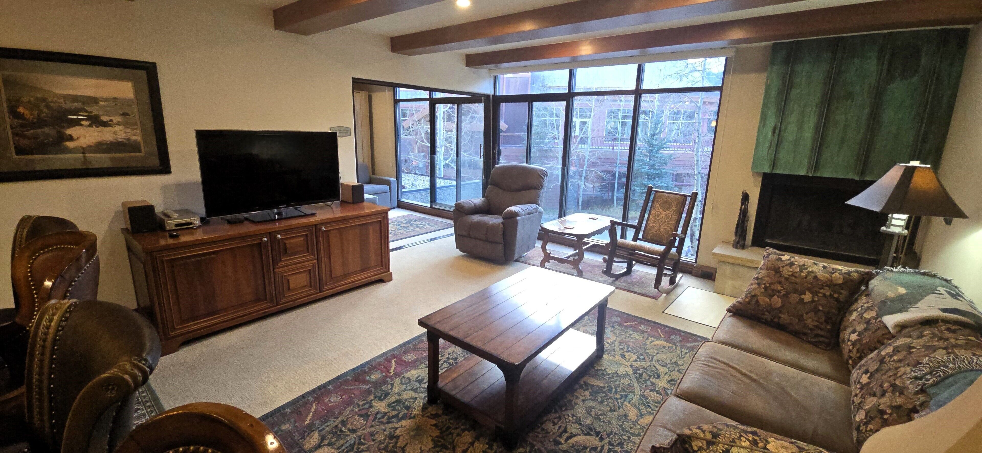 Living Room with Den beyond.  Large windows overlooking Copper Mountain