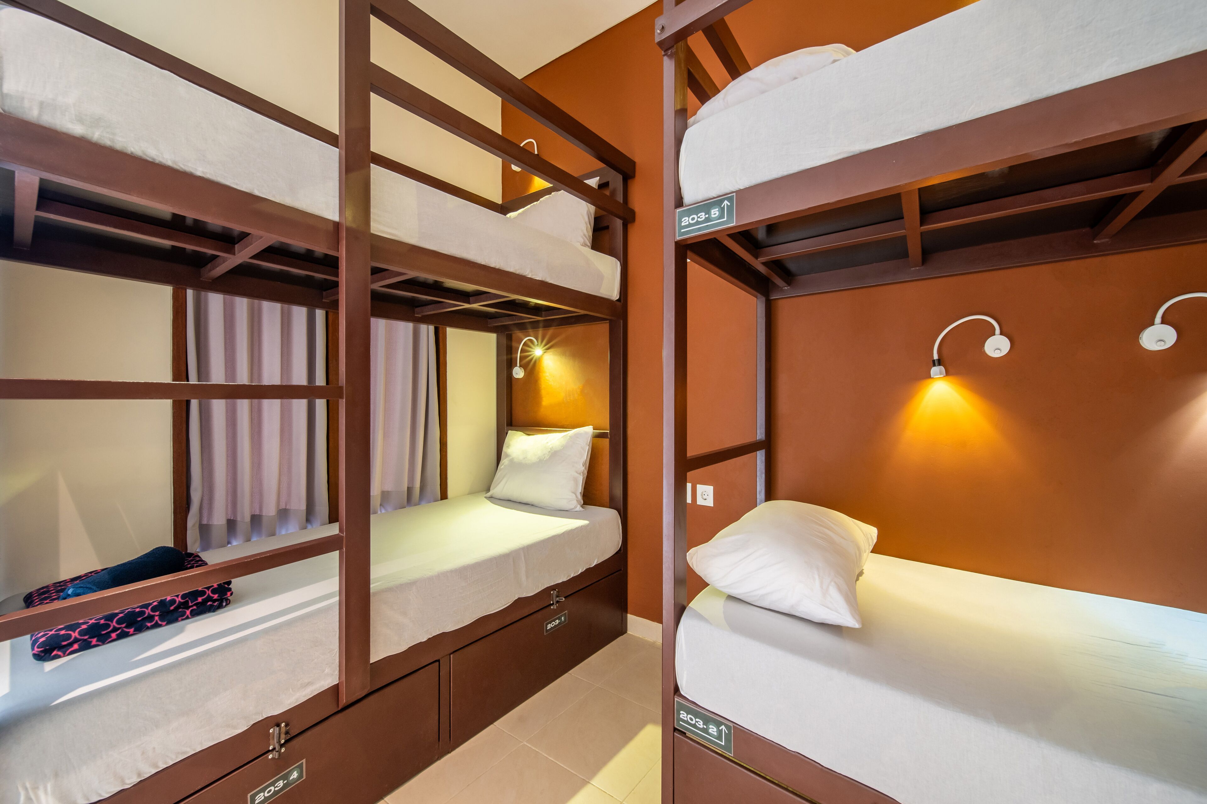 A bunk bed room with a sign indicating room number 203.5.