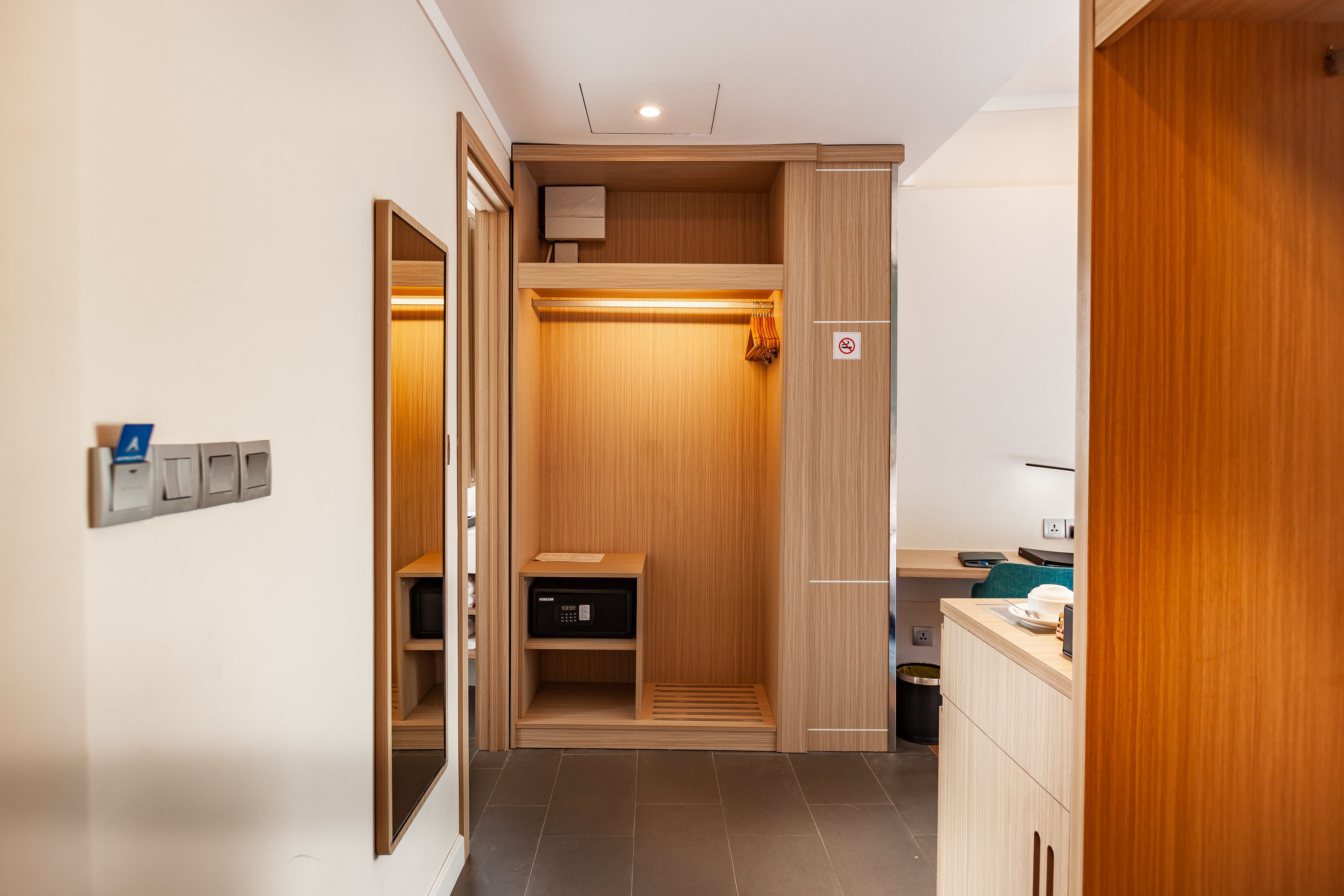 A modern bathroom with a wooden vanity, a shower area, and a built-in toilet.