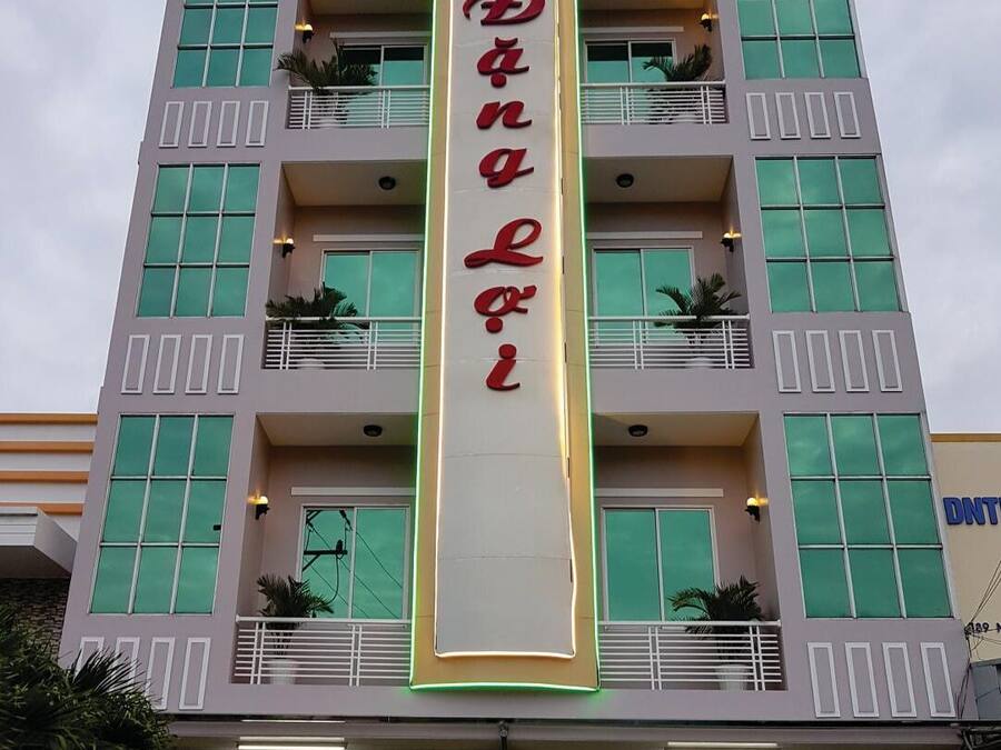 A hotel with a vertical sign reading "Danna Hotel" and balconies with plants.