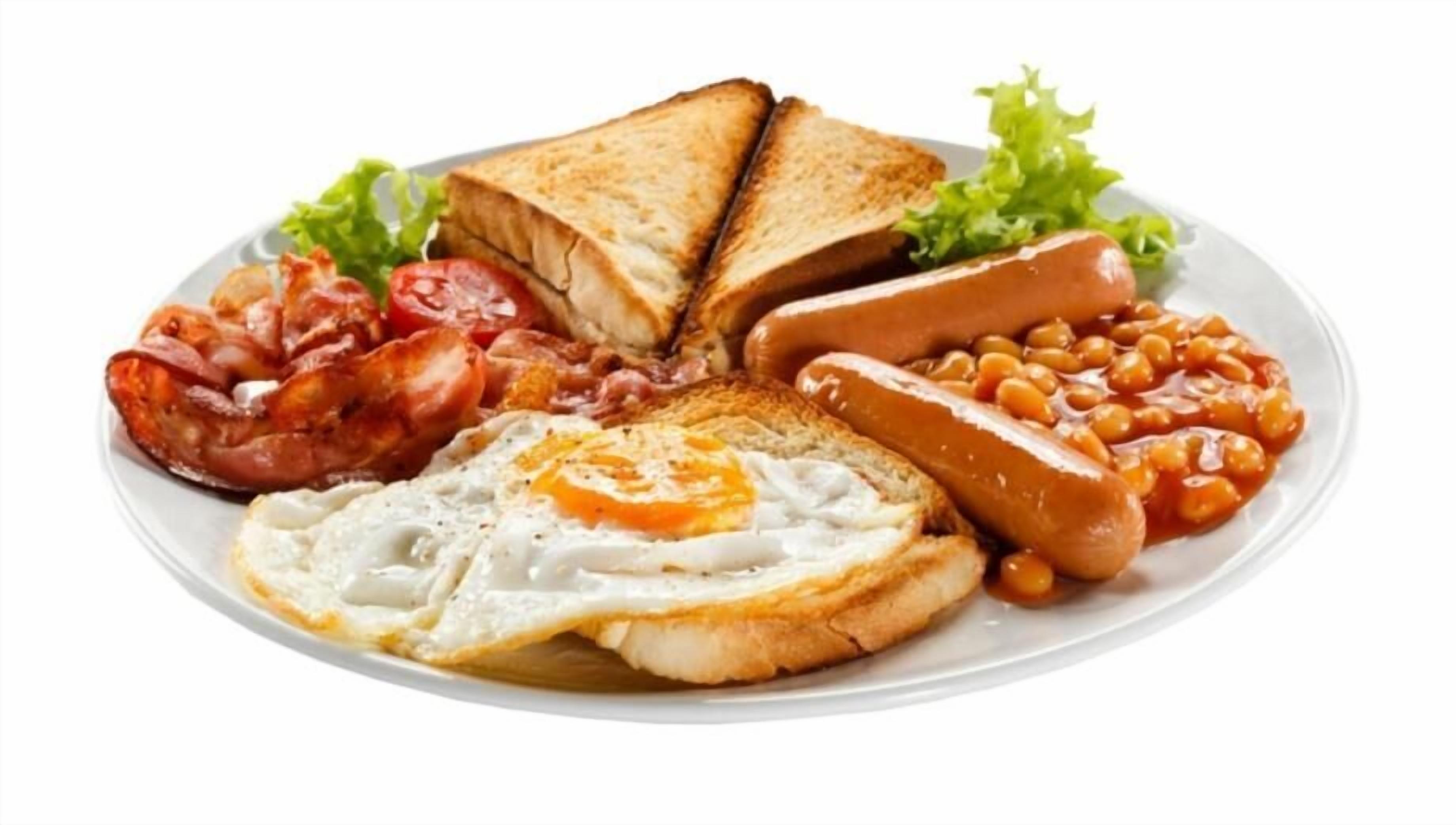 A plate of breakfast food including toast, eggs, sausages, beans, and bacon.