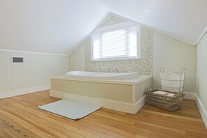 Tina con regadera, tina de hidromasaje, secadora de cabello, toallas 