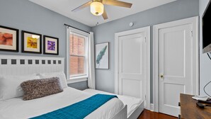 A bedroom with a bed, a ceiling fan, a window with blinds, and a door. - Family Friendly , Fully Renovated 3BR Luxury Home. Centrally located in St.Louis (St. Louis)