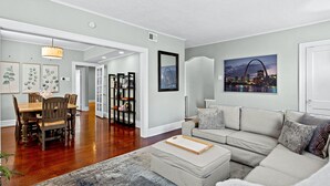 A spacious living room with a dining area, a sofa, and a coffee table. - Family Friendly , Fully Renovated 3BR Luxury Home. Centrally located in St.Louis (St. Louis)