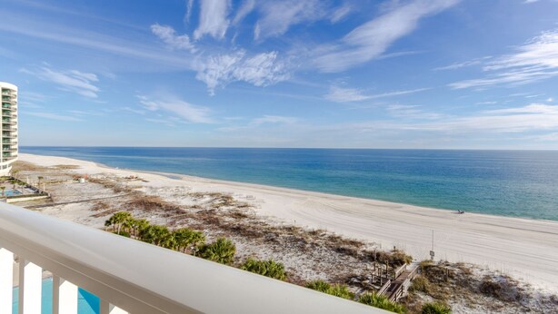 A beach view from a balcony with a clear sky and ocean. - Regency Isle 608 by Liquid Life (Orange Beach)