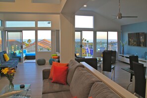 Living (foreground), Lounge (left) and Family (60" TV) rooms with ocean views