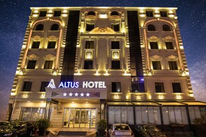 The exterior of the Altus Hotel with illuminated signage and a star rating of four and a half stars. -  Altus Hotel Baku - Free Massage (Baku)