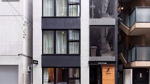A modern multi-story building with a sign reading "SPATIUM" at the entrance. - Spatium Ginza (Tokyo)
