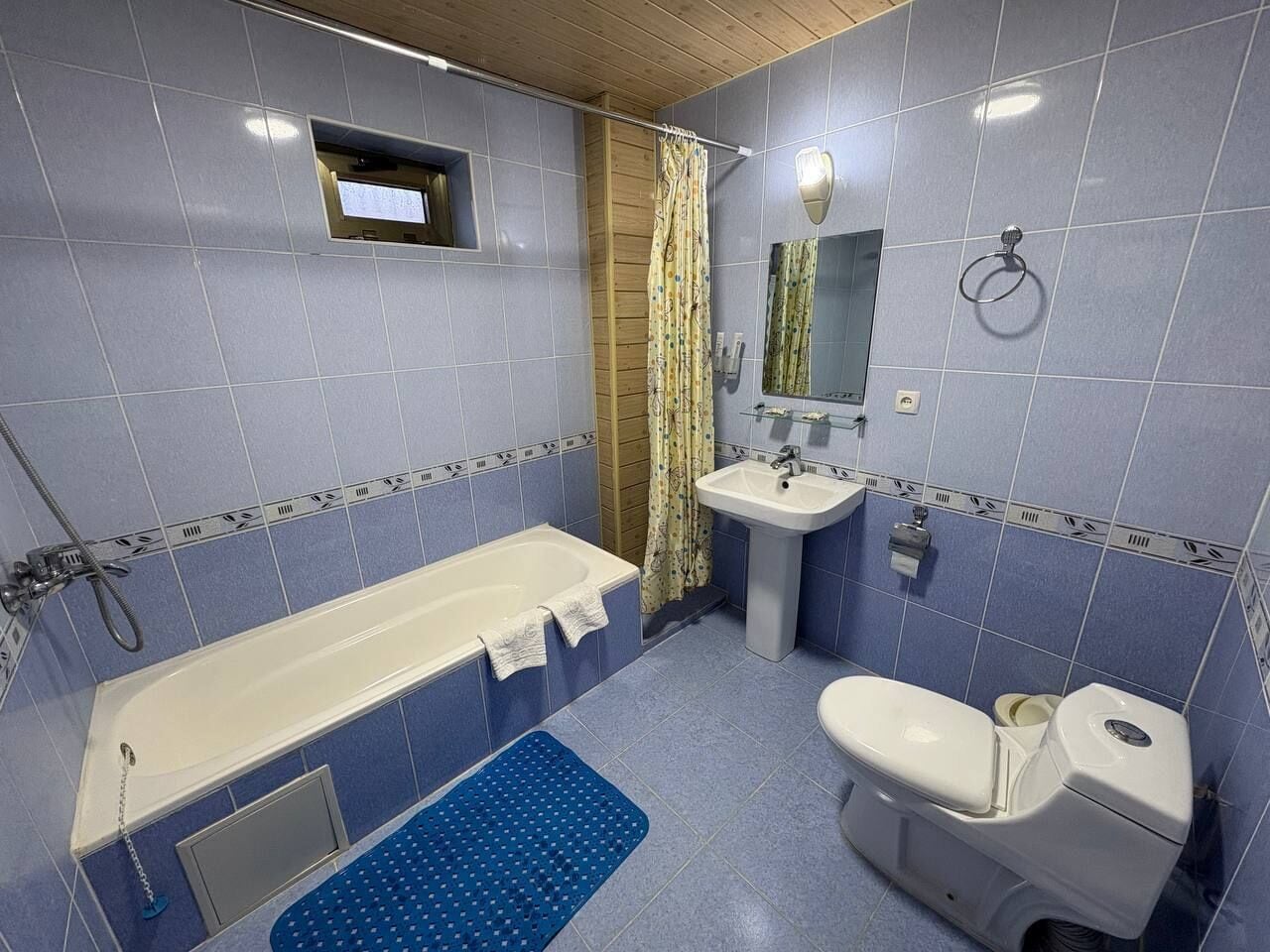 A bathroom with a bathtub, a sink, and a toilet.